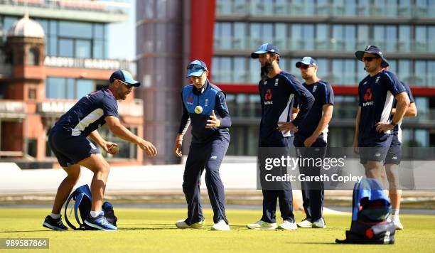 Joe Root, Moeen Ali, Dawid Malan and David Willey of England takes part in a fielding drill with fielding coach Carl Hopkinson during a net session...