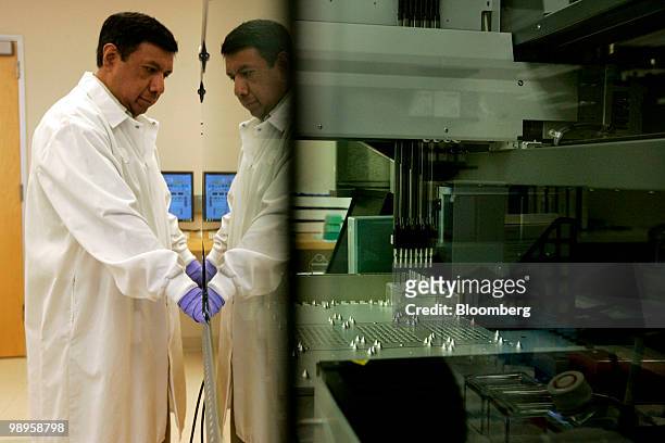 Lab technician Frank Aquino moniters DNA samples being tested at Pathway Genomics Corp. In San Diego, California, U.S., on Monday, May 10, 2010....
