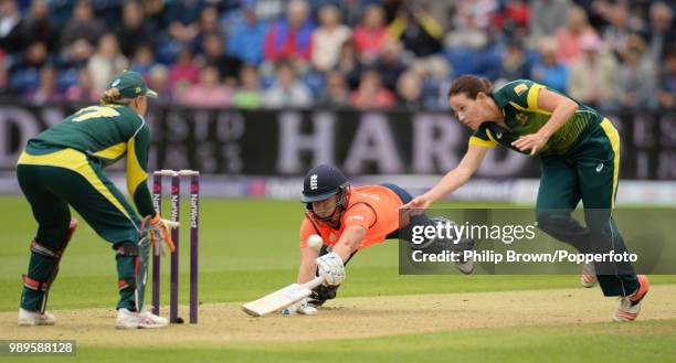 Katherine Brunt of England dives into her crease as Megan Schutt of Australia shies at the stumps during the 3rd NatWest International Twenty20...