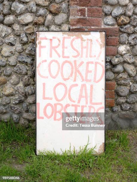 Handpainted sign advertising freshly cooked local lobsters for sale in the village of Salthouse along the North Norfolk coast on 8th June 2018