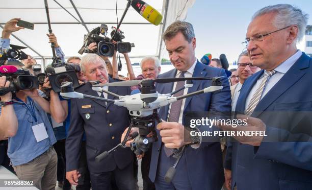 Bavaria's State Premier Markus Soeder of the conservative Christian Social Union party and Bavaria's interior minister Joachim Herrmann are shown a...