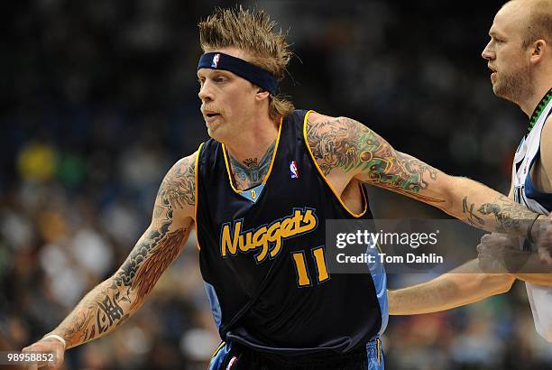 Chris Andersen of the Denver Nuggets posts up against Brian Cardinal of the Minnesota Timberwolves during the game on November 25, 2009 at the Target...