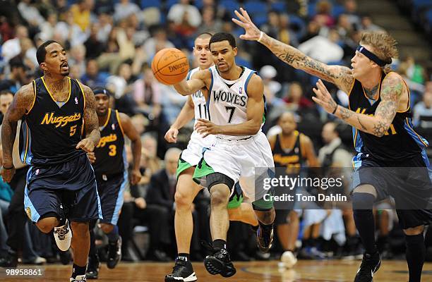 Ramon Sessions of the Minnesota Timberwolves drives the ball up court against Chris Andersen and J.R. Smith of the Denver Nuggets during the game on...