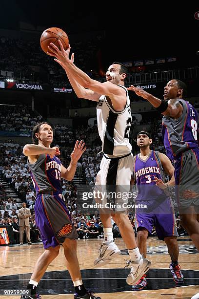 Manu Ginobili of the San Antonio Spurs goes up for a shot over Steve Nash, Jared Dudley and Channing Frye of the Phoenix Suns in Game Three of the...