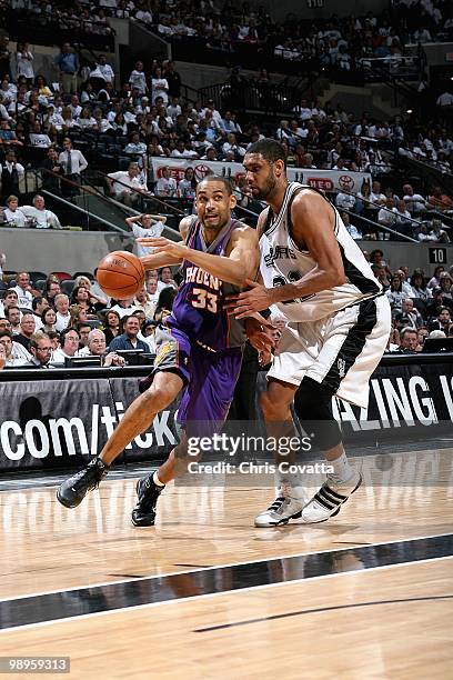 Grant Hill of the Phoenix Suns drives to the basket past Tim Duncan of the San Antonio Spurs in Game Three of the Western Conference Semifinals...