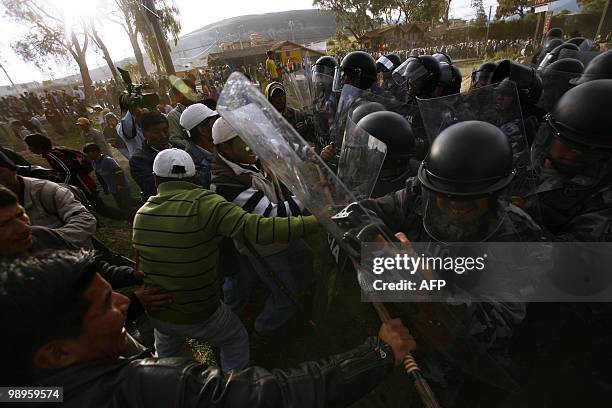 Ecuadorean natives clash with the police in Guachala, some 30 km from Quito, on May 10, 2010 in protest of a proposed water privatization measure...