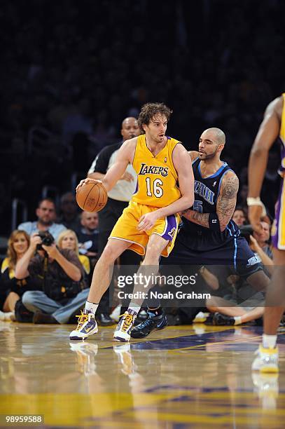 Pau Gasol of the Los Angeles Lakers dribbles the ball against Carlos Boozer of the Utah Jazz at Staples Center on April 2, 2010 in Los Angeles,...