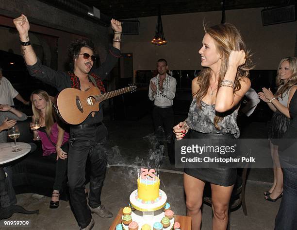 Ryan Cabrera watches as Audrina Patridge blows out the candles during her 25th birthday at Las Palmas Latin Supper Club on May 9, 2010 in Hollywood,...