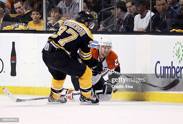 Patrice Bergeron of the Boston Bruins tries to get the puck from Ville Leino of the Philadelphia Flyers in Game Five of the Eastern Conference...