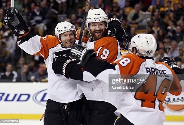 Scott Hartnell of the Philadelphia Flyers is congratulated by teammates Kimmo Timonen and Danny Briere after Hartnell scored in the second period...