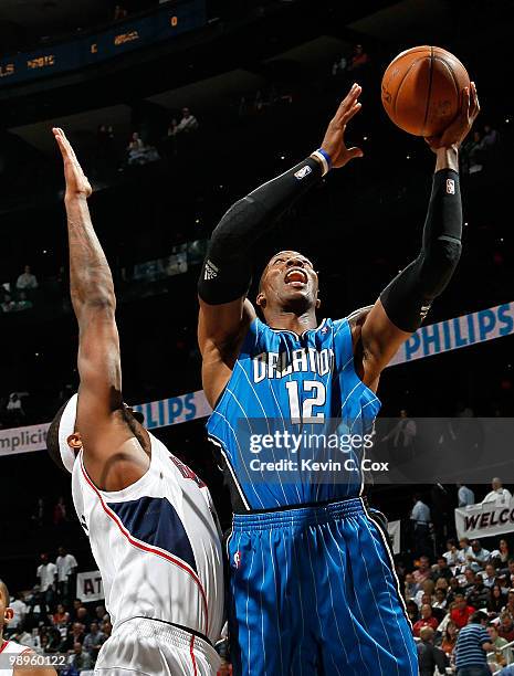 Dwight Howard of the Orlando Magic shoots against Josh Smith of the Atlanta Hawks during Game Four of the Eastern Conference Semifinals of the 2010...