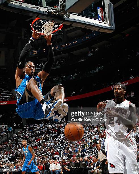 Dwight Howard of the Orlando Magic dunks against Marvin Williams of the Atlanta Hawks during Game Four of the Eastern Conference Semifinals of the...