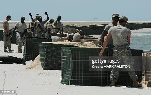 Members of the Alabama National Guard prepare a sea wall as a defense against the expected oil slick from the BP Deepwater Horizon platform disaster,...