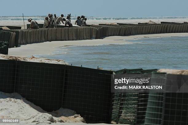 Members of the Alabama National Guard prepare a sea wall as a defense against the expected oil slick from the BP Deepwater Horizon platform disaster,...