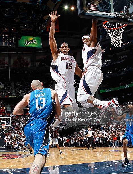 Al Horford and Josh Smith of the Atlanta Hawks defend the basket against Marcin Gortat of the Orlando Magic during Game Four of the Eastern...