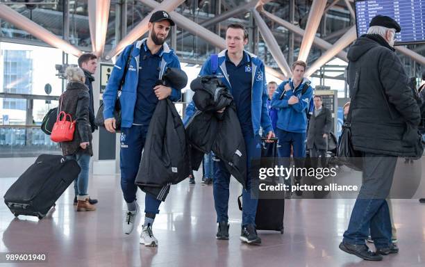 The players of the Hamburger SV soccer club, Mergim Mavraj and goalkeeper Tom Mickel walk through the departure terminal at the airport in Hamburg,...