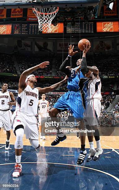 Dwight Howard of the Orlando Magic is defended by Josh Smith and Jamal Crawford of the Atlanta Hawks in Game Four of the Eastern Conference...