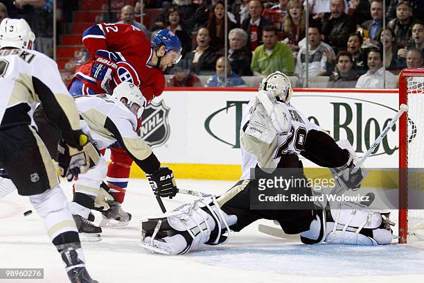 Marc-Andre Fleury of the Pittsburgh Penguins stretches to stop the puck on a shot by Travis Moen of the Montreal Canadiens in Game Six of the Eastern...