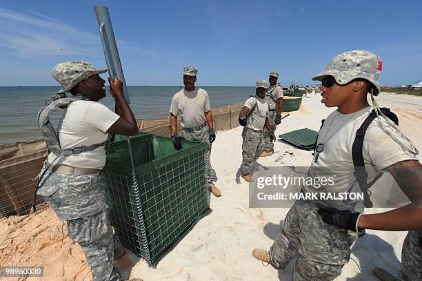 Members of the Alabama National Guard prepare a sea wall as a defense against the expected oil slick from the BP Deepwater Horizon platform disaster,...