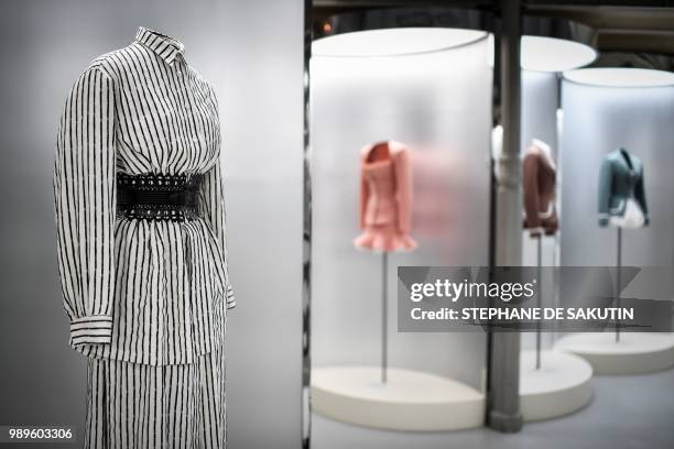This photo taken on July 2, 2018 shows creations displayed at the exhibition "L'Alchimie Secrete d'Une Collection" by late French-Tunisian fashion...