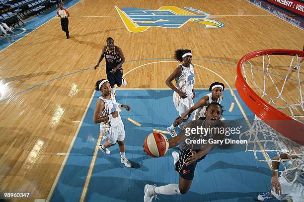 Ashley Battle of the Indiana Fever goes to the basket past Tamera Young and Sylvia Fowles of the Chicago Sky during the WNBA pre season game on May...