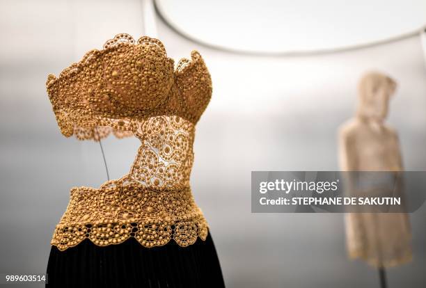 This photo taken on July 2, 2018 shows a creation displayed at the exhibition "L'Alchimie Secrete d'Une Collection" by late French-Tunisian fashion...