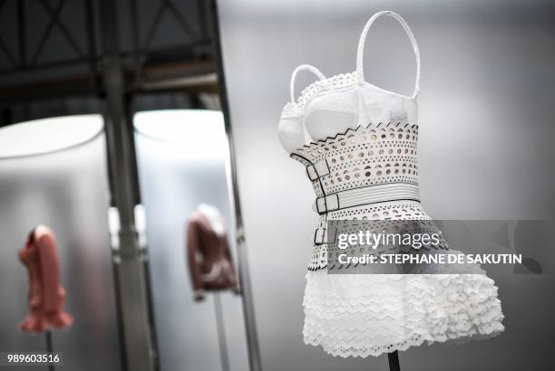 This photo taken on July 2, 2018 shows a creation displayed at the exhibition "L'Alchimie Secrete d'Une Collection" by late French-Tunisian fashion...