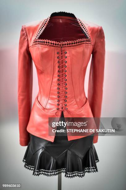 This photo taken on July 2, 2018 shows a creation displayed at the exhibition "L'Alchimie Secrete d'Une Collection" by late French-Tunisian fashion...