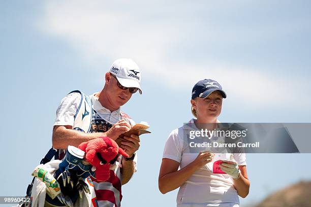 Stacy Lewis and caddie Travis Wilson discuss shot selection during the fourth round of the Tres Marias Championship at the Tres Marias Country Club...