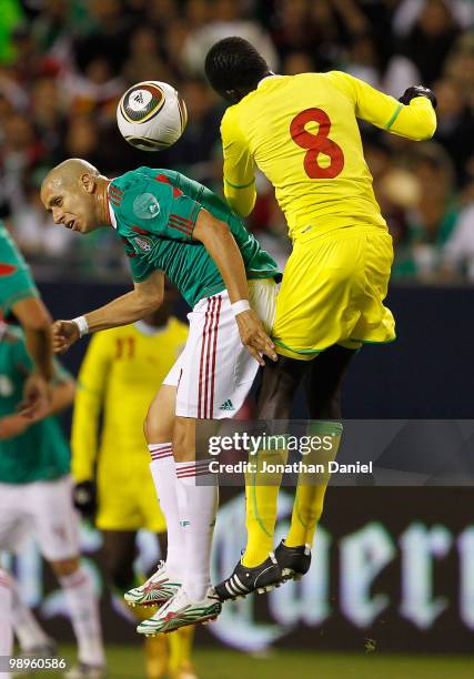 Adolfo Bautista of Mexico battles for a header with Babacar Ndiour of Senegal during an international friendly at Soldier Field on May 10, 2010 in...