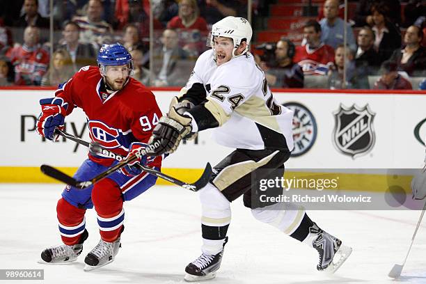 Matt Cooke of the Pittsburgh Penguins attempts to deflect the puck in front of Tom Pyatt of the Montreal Canadiens in Game Six of the Eastern...