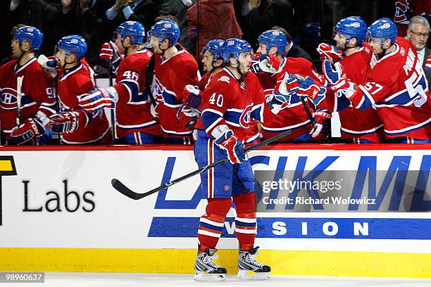 Maxim Lapierre of the Montreal Canadiens celebrates his third-period goal against the Pittsburgh Penguins with teammates in Game Six of the Eastern...