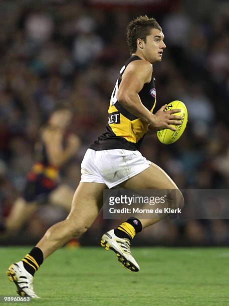 Dustin Martin of the Tigers runs with the ball during the round seven AFL match between the Adelaide Crows and the Richmond Tigers at AAMI Stadium on...