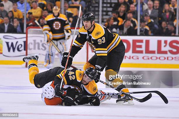 Trent Whitfield of the Boston Bruins falls on top of Ville Leino of the Philadelphia Flyers in Game Five of the Eastern Conference Semifinals during...