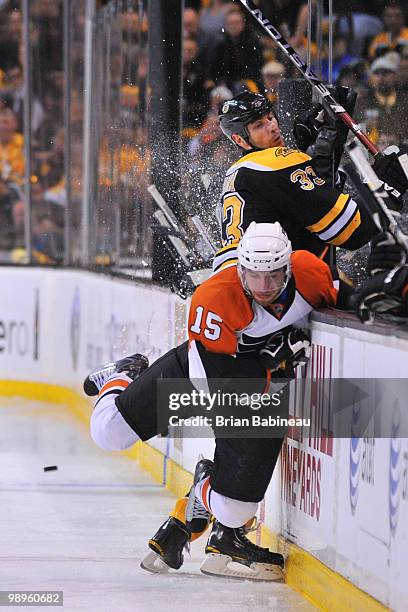 Andreas Nodi of the Philadelphia Flyers checks Zdeno Chara of the Boston Bruins in Game Five of the Eastern Conference Semifinals during the 2010 NHL...