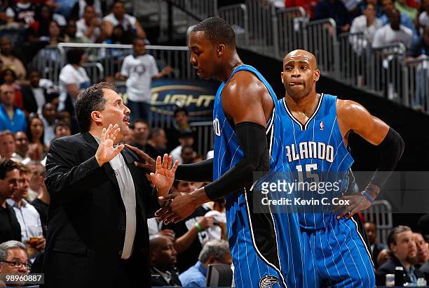Vince Carter looks on as head coach Stan Van Gundy of the Orlando Magic converses with Dwight Howard after he was called for a technical foul against...