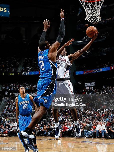 Dwight Howard of the Orlando Magic defends the basket against Joe Johnson of the Atlanta Hawks during Game Four of the Eastern Conference Semifinals...