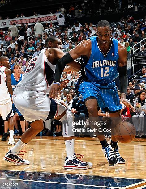 Dwight Howard of the Orlando Magic drives past Al Horford of the Atlanta Hawks during Game Four of the Eastern Conference Semifinals of the 2010 NBA...