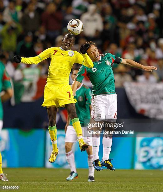 Lamine Yoro Ly of Senegal beats Gerardo Torrado of Mexico to a header during an international friendly at Soldier Field on May 10, 2010 in Chicago,...