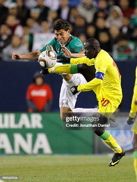 Hector Moreno of Mexico and Djibril Sidibe of Senegal battle for control of the ball during an international friendly at Soldier Field on May 10,...