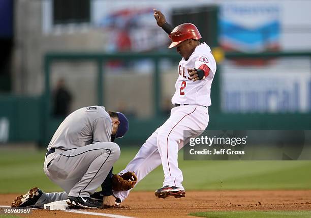 Erick Aybar of the Los Angeles Angels of Anaheim advances to third on a hit by Bobby Abreu as third baseman Evan Longoria of the Tampa Bay Rays drops...