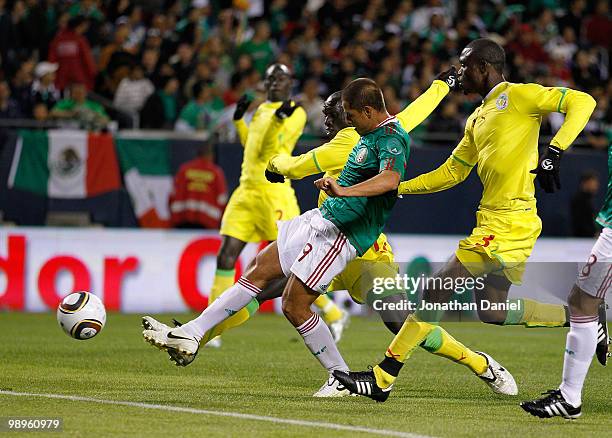 Javier Hernandez of Mexico fires a shot on goal between Ferdinand Gomis and Alpha Ba of Senegal during an international friendly at Soldier Field on...