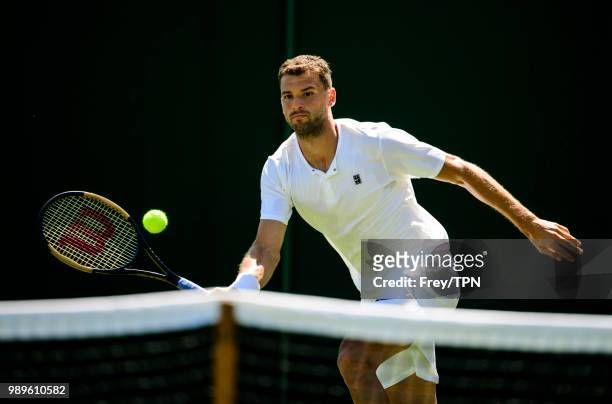 Grigor Dimitrov of Bulgaria practices before the Championships at the All England Lawn Tennis and Croquet Club in Wimbledon on June 30, 2018 in...