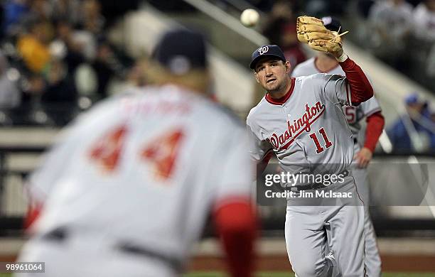Ryan Zimmerman of the Washington Nationals tosses the ball to teammate Adam Dunn to force out David Wright of the New York Mets to complete a sixth...