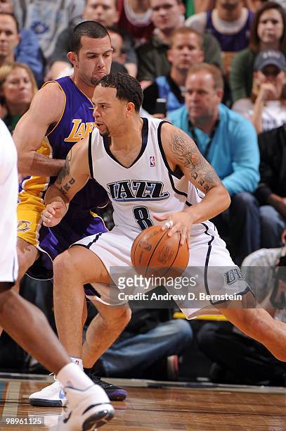 Deron Williams of the Utah Jazz drives against Jodan Farmar of the Los Angeles Lakers in Game Four of the Western Conference Semifinals during the...