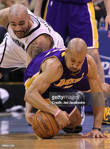 Derek Fisher of the Los Angeles Lakers scrambles for the ball with Carlos Boozer of the Utah Jazz during Game Four of the Western Conference...