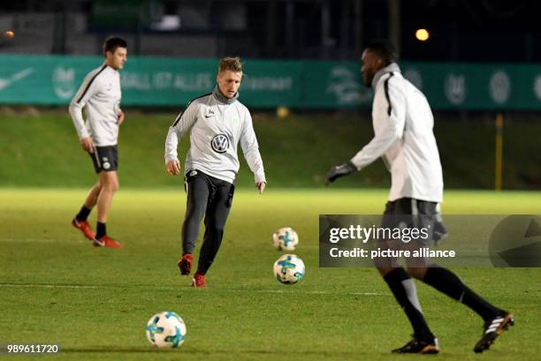 Wolfsburg's Robin Knoche , Marvin Stefaniak and Josuha Guilavogui in action with their team during the training of VfL Wolfsburg at the Volkswagen...