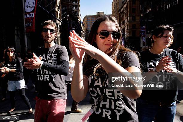 Members of the Make Poverty History campaign dance during a musical flash mob performance at Martin Place on May 11, 2010 in Sydney, Australia. The...