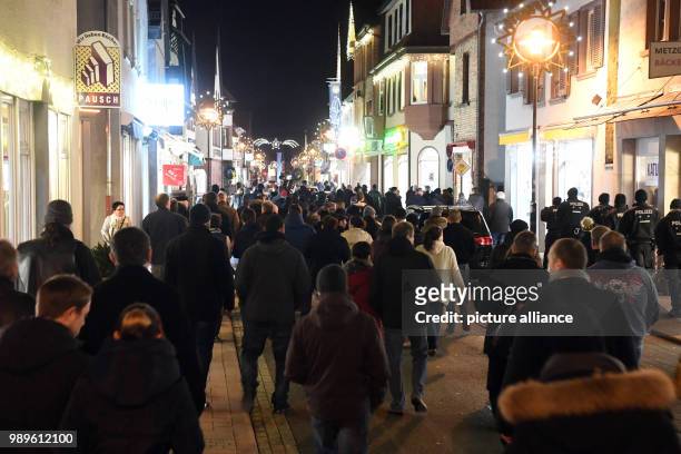 Mourners take part in a funeral march in memory of a 15-year-old girl, who was stabbed by her boyfriend in the store, in Kandel, Germany, 02 January...