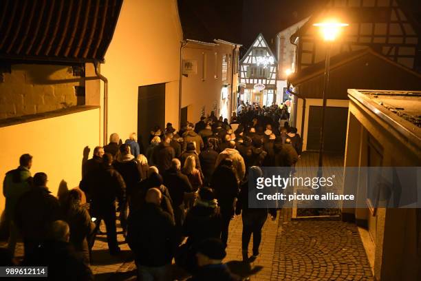 Mourners take part in a funeral march in memory of a 15-year-old girl, who was stabbed by her boyfriend in the store, in Kandel, Germany, 02 January...